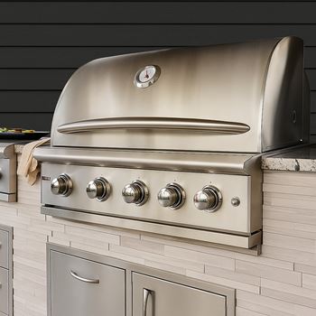 A stainless steel oven with a clock on the front and four burners below it.